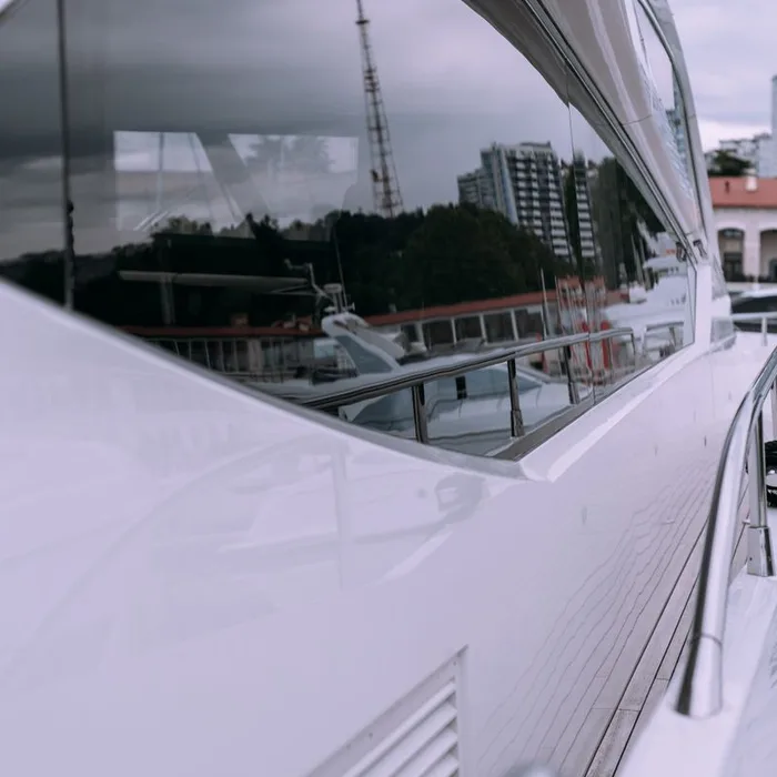 Tinted yacht window reflecting the Miami marina