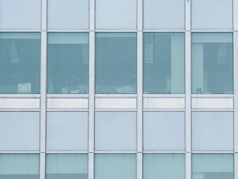 Tinted glass facade of a commercial office building