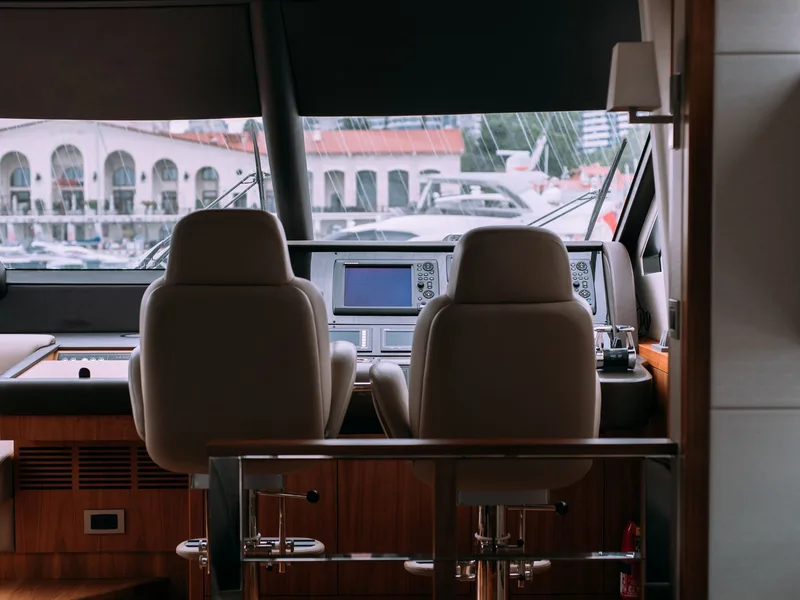 Yacht cockpit with tinted windows overlooking a marina