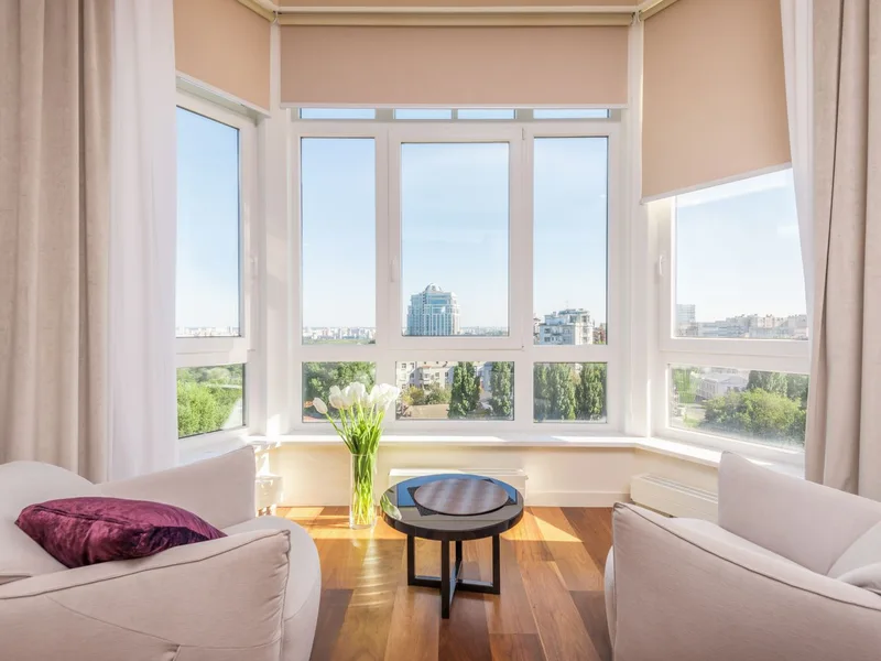 Sunlit living room with floor-to-ceiling windows and sun-control film